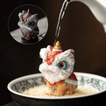 Dansande lejon tea pet i resin