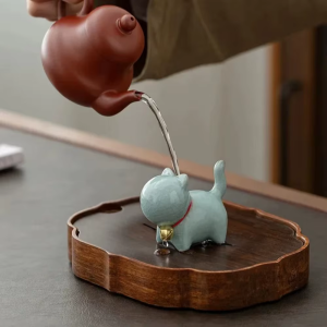 Keramisk tea pet-katt med rött halsband