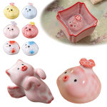 Tea pet i keramik föreställande en gris